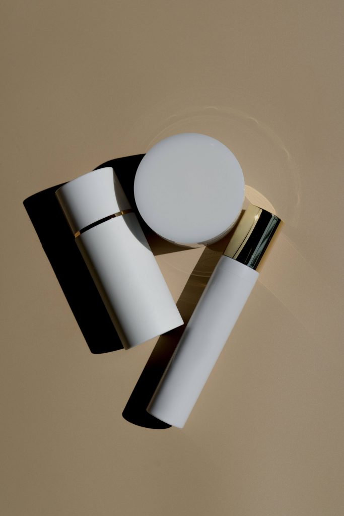 cosmetics cream and tube for skin hair and nails brown background on a table